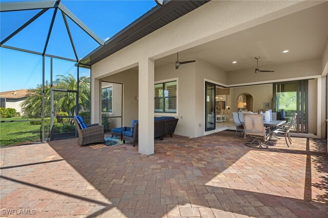 view of patio / terrace featuring ceiling fan, outdoor lounge area, and a lanai