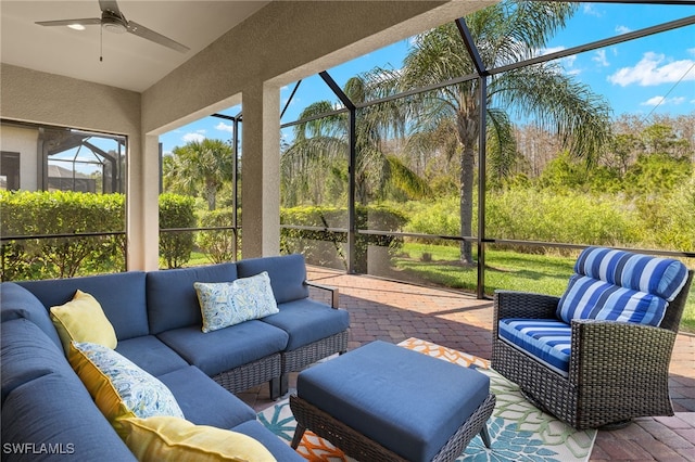 sunroom with a healthy amount of sunlight and ceiling fan