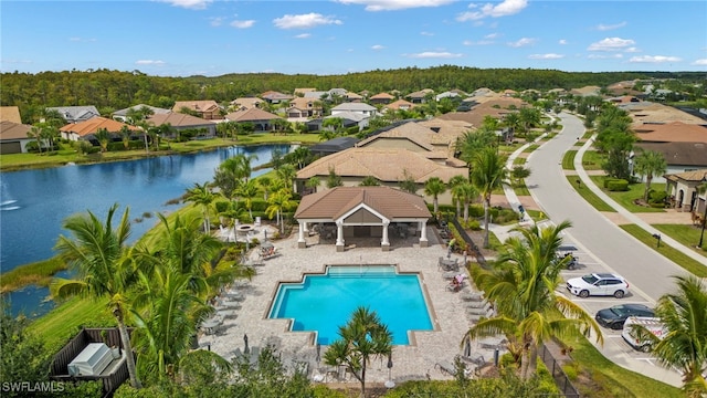 pool with a gazebo, a water view, fence, and a residential view