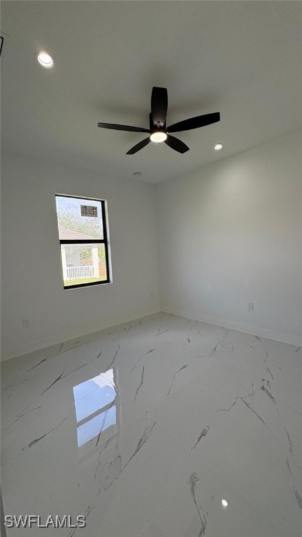 spare room with marble finish floor, ceiling fan, baseboards, and recessed lighting