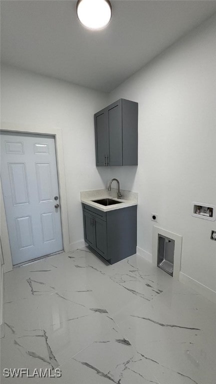 laundry area featuring cabinet space, marble finish floor, hookup for an electric dryer, washer hookup, and a sink