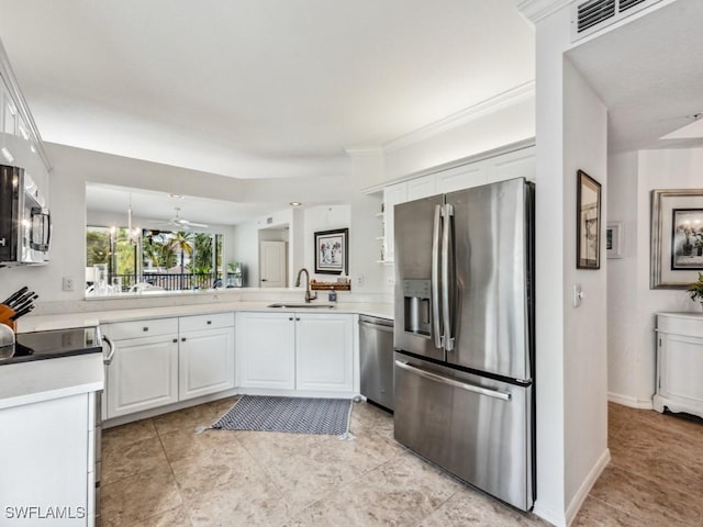 kitchen with white cabinets, stainless steel appliances, a sink, and light countertops