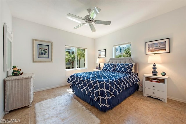 bedroom with multiple windows, baseboards, a ceiling fan, and light tile patterned flooring