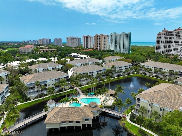 birds eye view of property featuring a water view and a city view