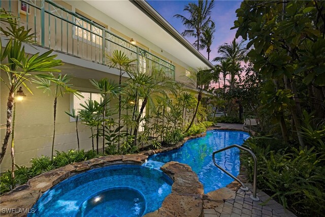 445 3rd Ave S Unit 102, Naples, FL 34102 - pool at dusk featuring a pool with connected hot tub