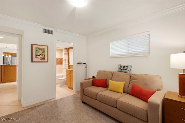 445 3rd Ave S Unit 102, Naples, FL 34102 - living room with light tile patterned flooring and crown molding
