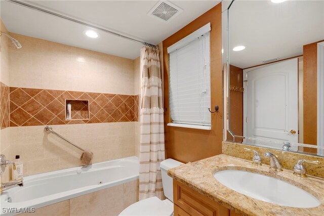 445 3rd Ave S Unit 102, Naples, FL 34102 - bathroom featuring tiled shower / bath combo, vanity, and recessed lighting