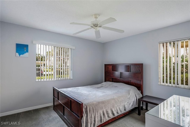 carpeted bedroom with a ceiling fan and baseboards