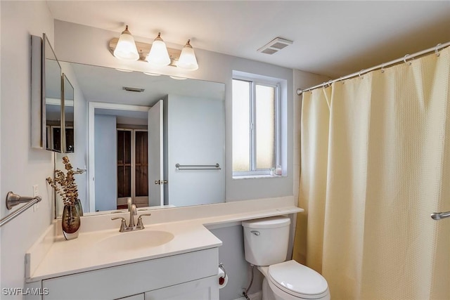 full bathroom featuring vanity, toilet, and visible vents