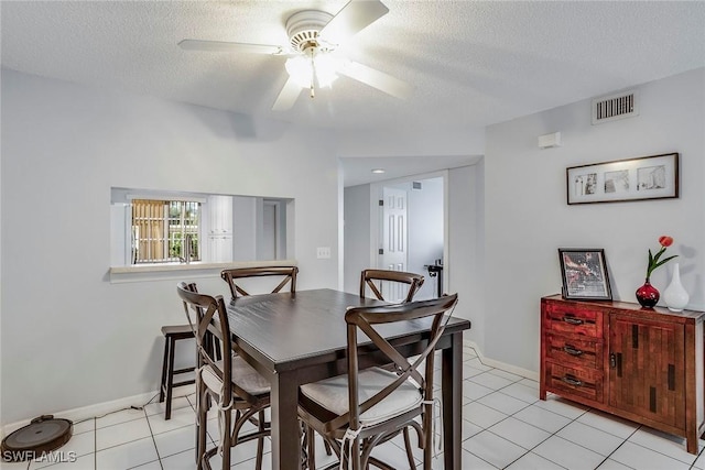 dining room with visible vents, a textured ceiling, ceiling fan, and light tile patterned flooring