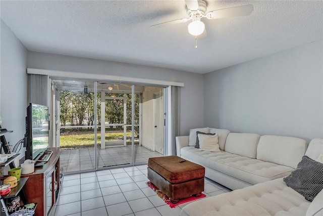 living room featuring light tile patterned floors, a textured ceiling, and ceiling fan