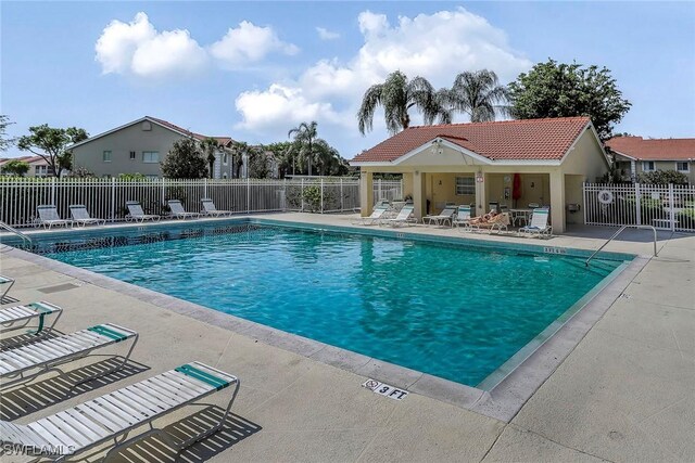 pool featuring a patio and fence