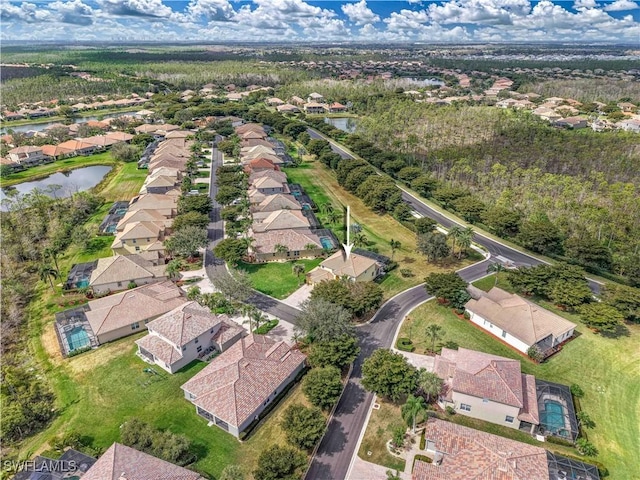 drone / aerial view featuring a water view and a residential view