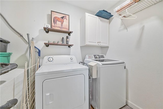 laundry area with washer and clothes dryer, cabinet space, and baseboards