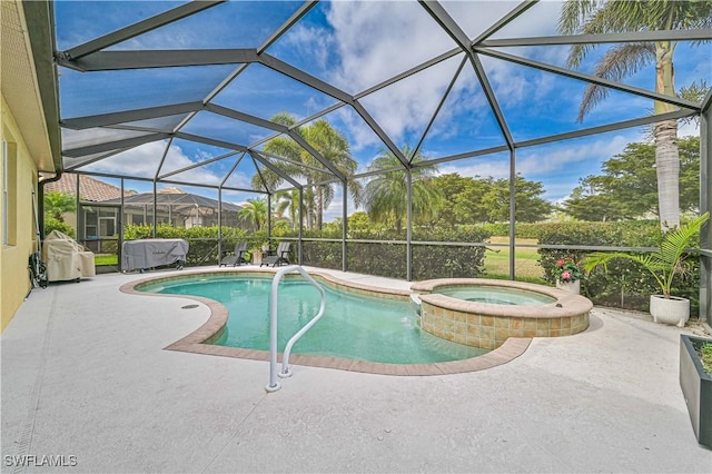 view of pool featuring glass enclosure, a pool with connected hot tub, and a patio