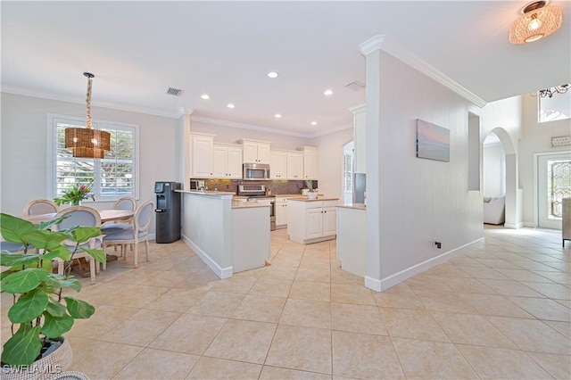 kitchen featuring light tile patterned floors, light countertops, a peninsula, and stainless steel appliances