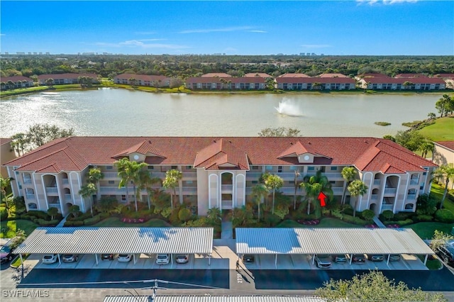 drone / aerial view with a water view and a residential view