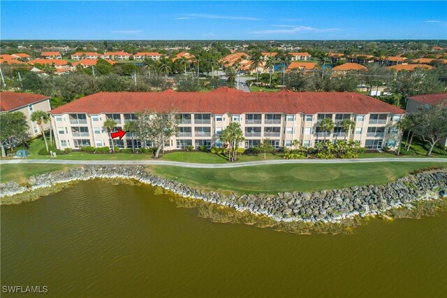 aerial view featuring golf course view and a water view