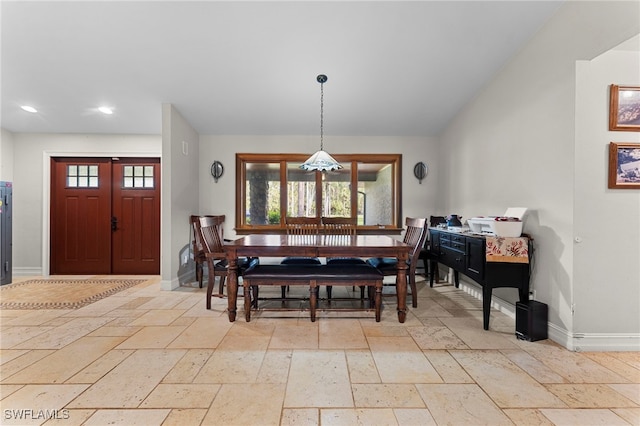 dining room featuring a wealth of natural light, recessed lighting, stone tile flooring, and baseboards