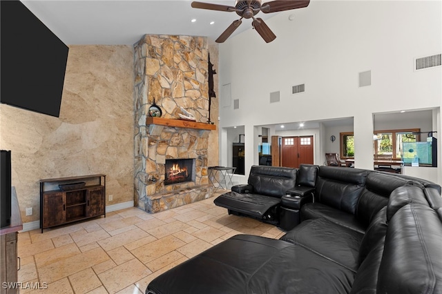 living area with a stone fireplace, visible vents, and stone tile floors