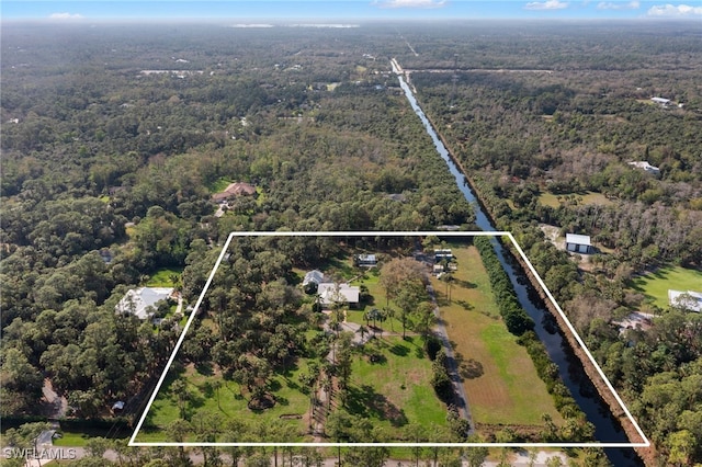 drone / aerial view featuring a view of trees