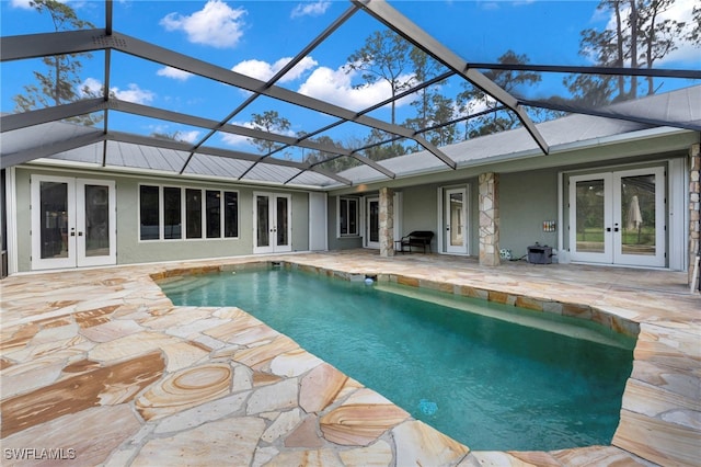 pool with french doors, a patio area, and a lanai