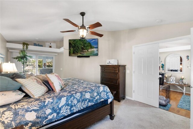 carpeted bedroom with ceiling fan, access to outside, lofted ceiling, and baseboards