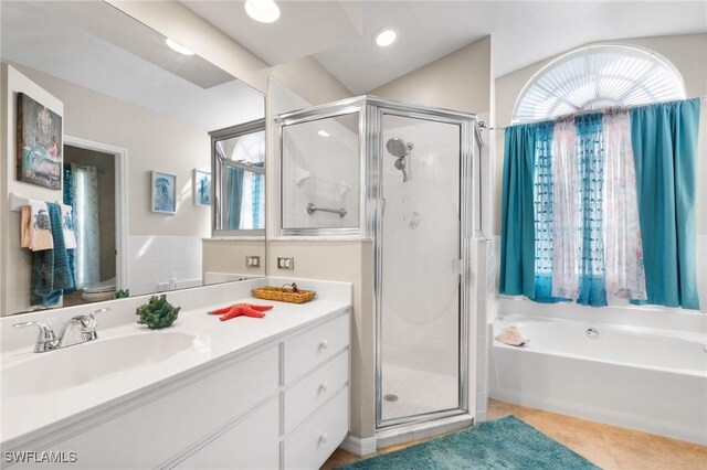 full bath featuring a stall shower, vanity, a bath, and tile patterned floors