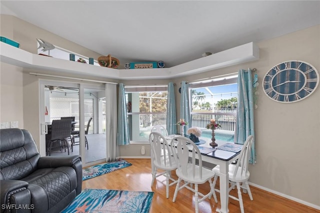 dining area featuring baseboards and wood finished floors