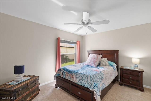 bedroom featuring a ceiling fan, light carpet, and baseboards