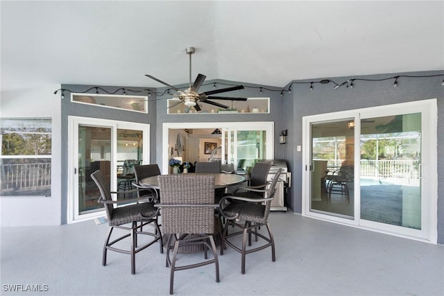 exterior space featuring concrete flooring, lofted ceiling, and a ceiling fan