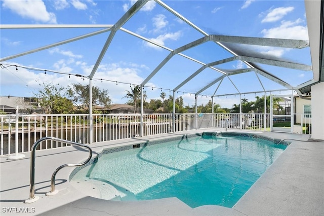 view of swimming pool with glass enclosure, a patio area, and a fenced in pool