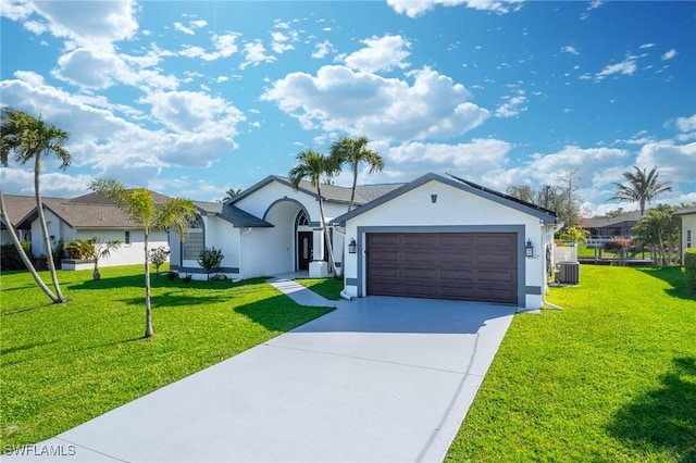 single story home featuring a garage, concrete driveway, a front yard, and stucco siding