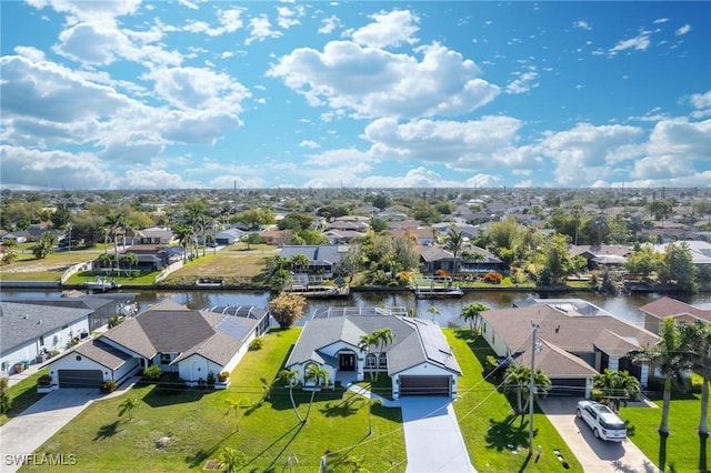 birds eye view of property featuring a water view and a residential view