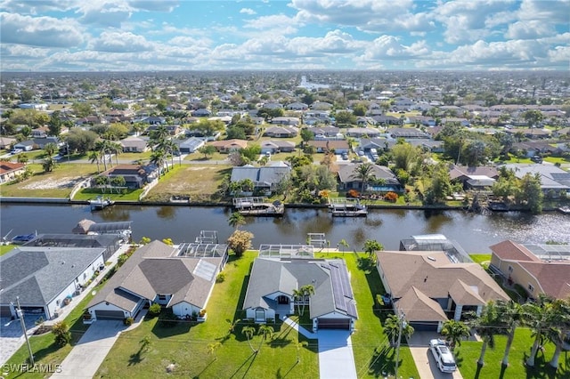 drone / aerial view featuring a water view and a residential view