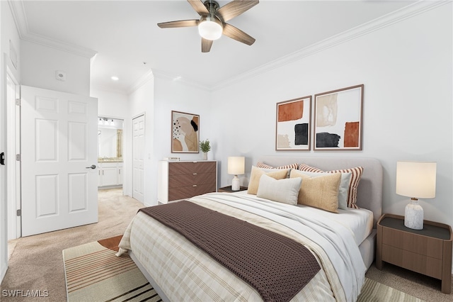 bedroom featuring a ceiling fan, light colored carpet, ornamental molding, and ensuite bathroom