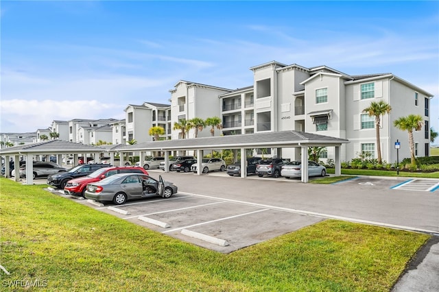 partially covered parking lot featuring a residential view