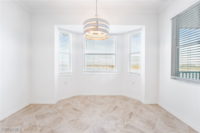 tiled spare room with a wealth of natural light, a chandelier, baseboards, and ornamental molding