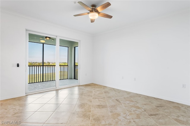 spare room featuring baseboards, crown molding, a ceiling fan, and a water view