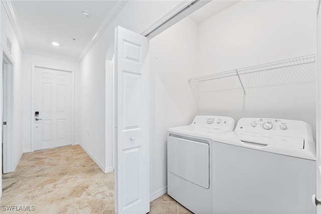 laundry room featuring visible vents, baseboards, laundry area, ornamental molding, and washer and dryer