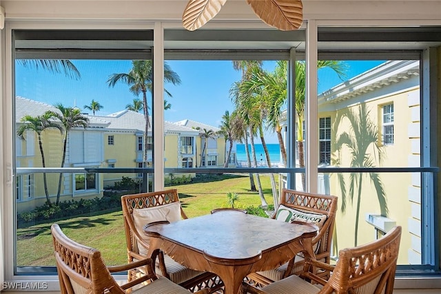 sunroom / solarium with a water view