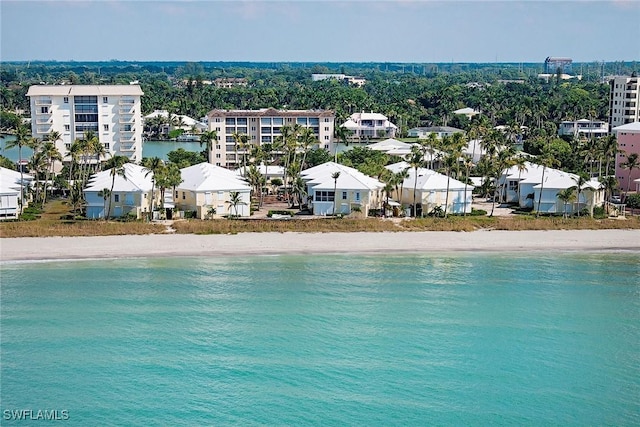 birds eye view of property with a view of the beach and a water view