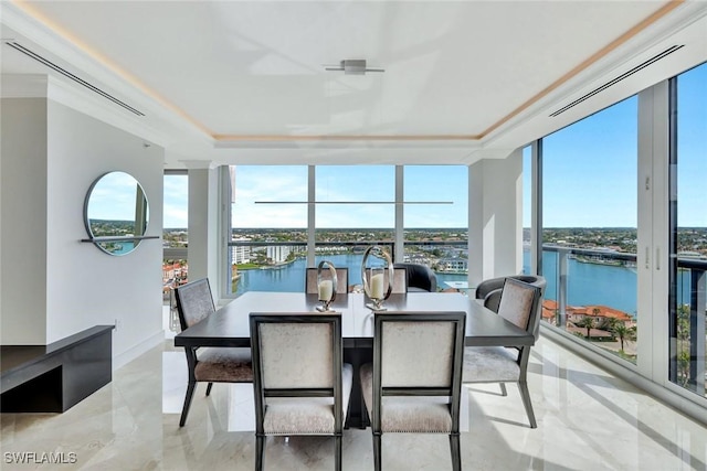 sunroom / solarium featuring a healthy amount of sunlight and a water view