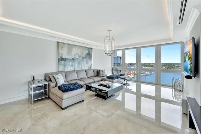 living area with marble finish floor, a tray ceiling, visible vents, and crown molding