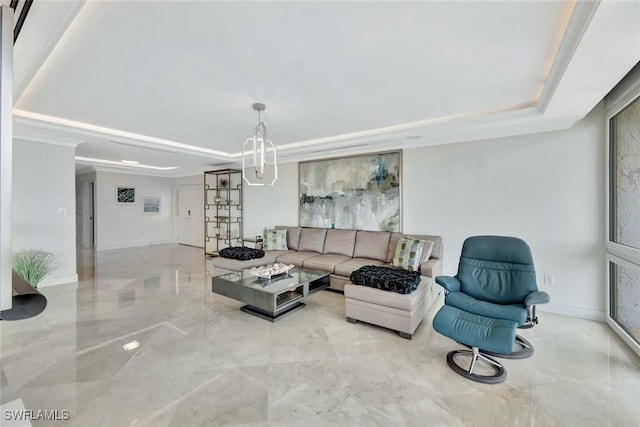 living area with baseboards and a tray ceiling