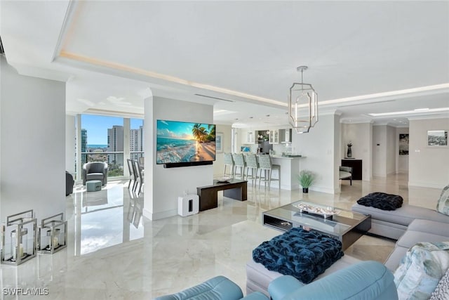 living area featuring a raised ceiling, crown molding, marble finish floor, and baseboards