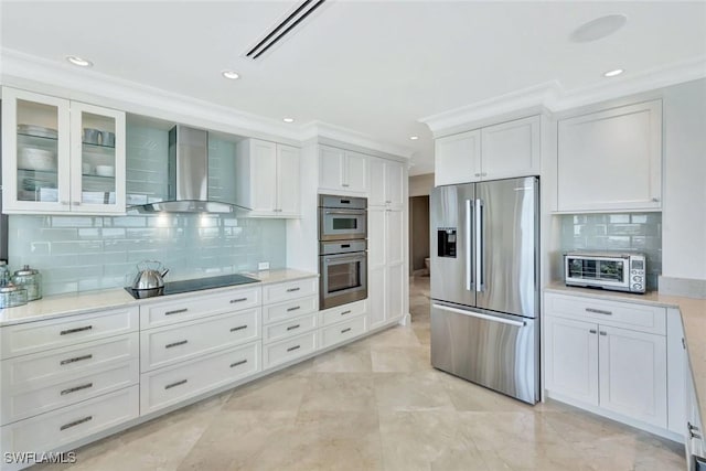 kitchen with stainless steel appliances, a toaster, white cabinets, and wall chimney exhaust hood