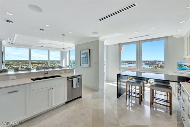 kitchen with visible vents, hanging light fixtures, stainless steel dishwasher, white cabinets, and a sink