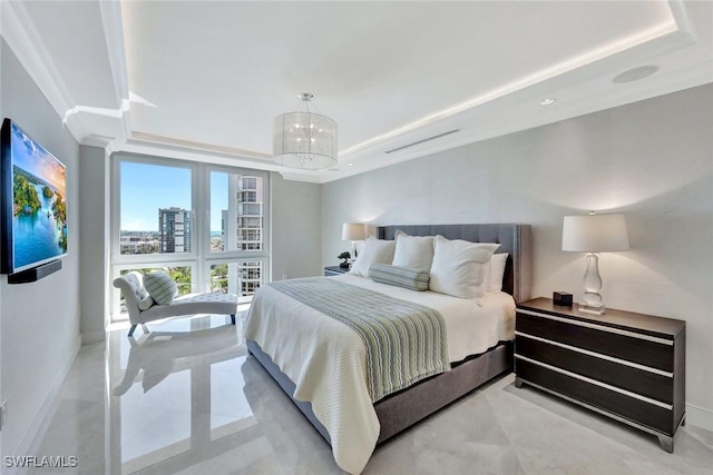 bedroom featuring a chandelier, a raised ceiling, and baseboards