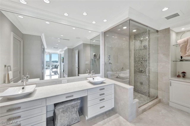 full bathroom with a shower stall, a sink, visible vents, and crown molding